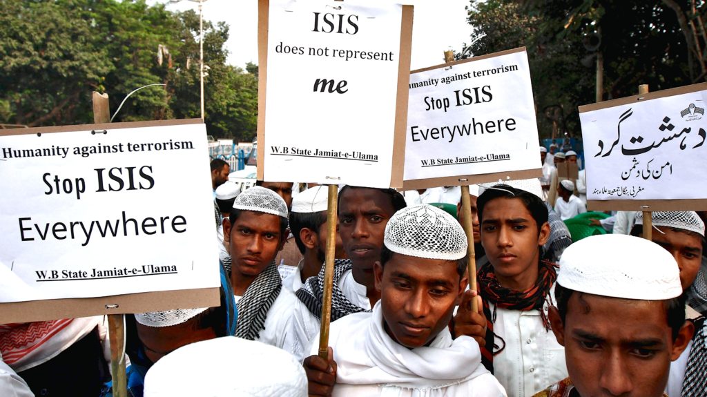Activists from a Muslim group hold placards during a protest rally against the Paris attacks in Kolkata